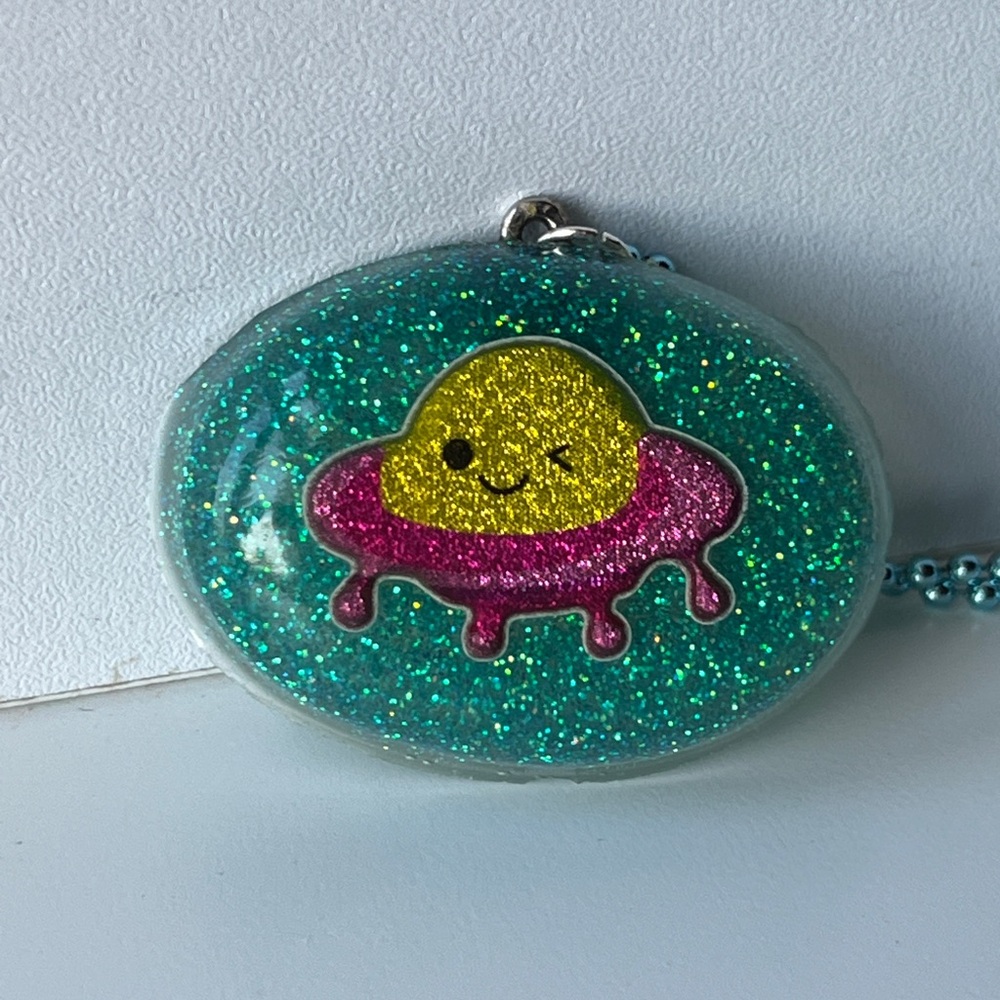 Glittery Teal and Pink Winking UFO  Resin Necklace